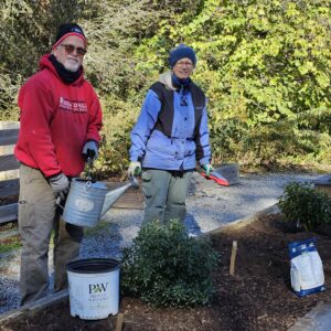 Paco and Betsy planting shrubs